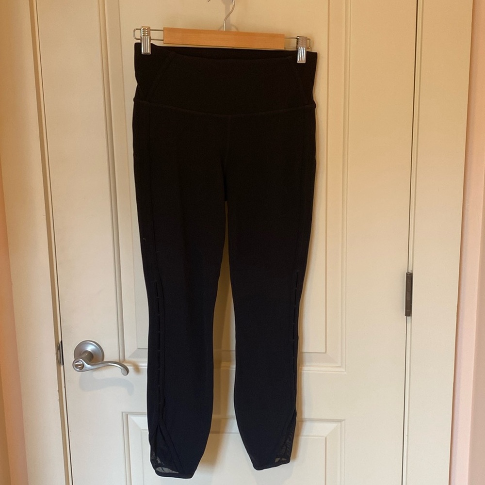 Athleta yoga pants with cutout and mesh inserts on legs